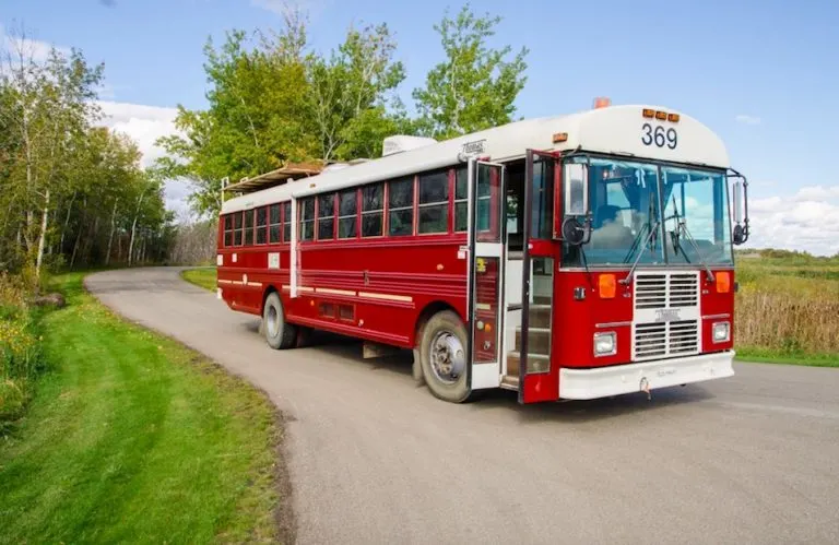 red school bus made into mobile home