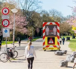Keep Distance of 1.5 meter Warning Sign on Digital Display in a public park. Amsterdam, Netherlands