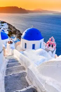 Santorini, Greece. Oia, white village with cobbled narrow paths, famous attraction of Greek Cyclades Islands, Aegean Sea.