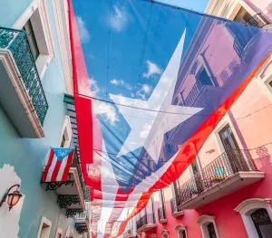city centre of San Juan with large Puerto Rican flag above the street