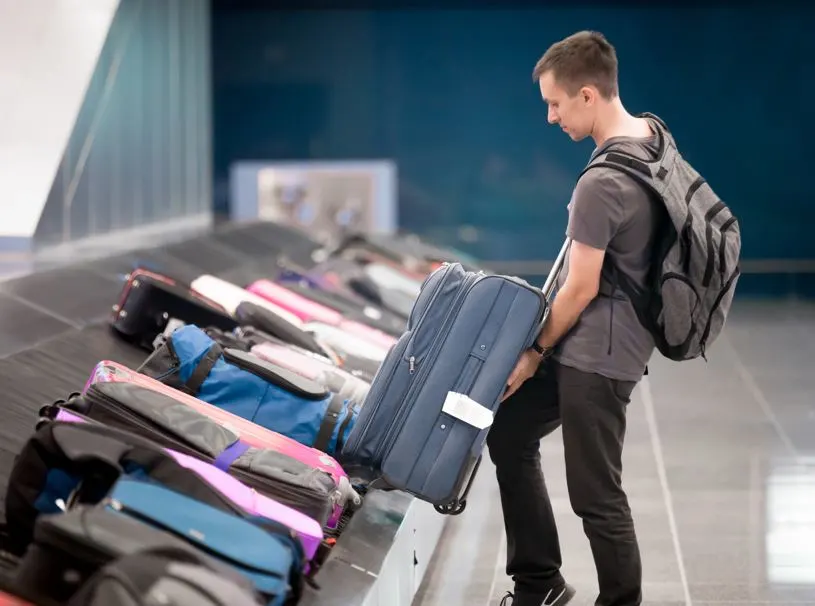 man collecting luggage