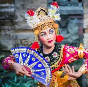 A young Bali female dancer is performing the Ramayana dance in a temple of Bali, in Indonesia. The Hindu culture in Bali is still preserved today and attracts millions of visitors in the Island of Gods for its the culture and natural beauty