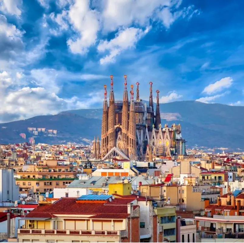 Sagrada Familia Basilica from a distance in Barcelona. mountain view in the background.
