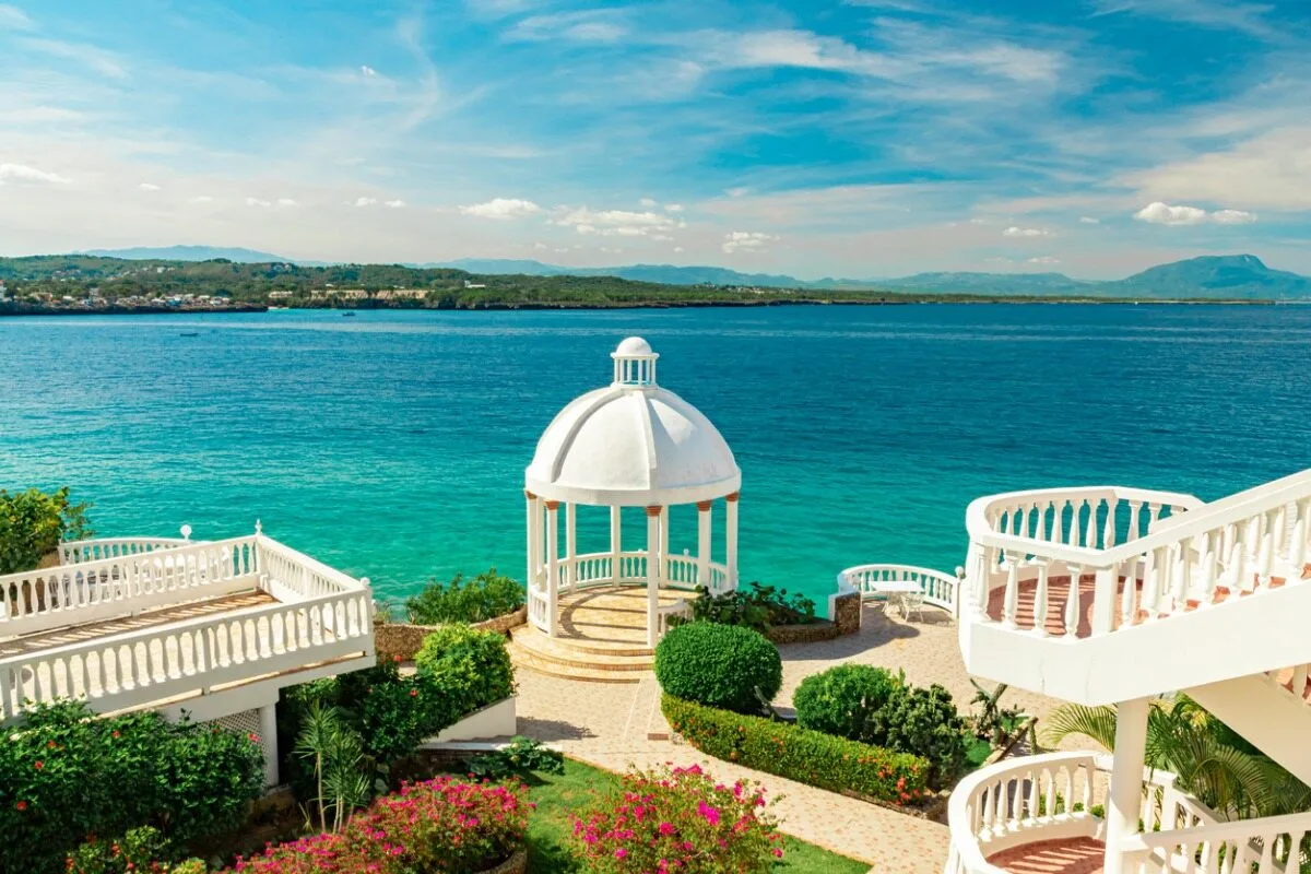Beautiful White Gazebo And Tropical Flower Garden On Caribbean Ocean Background, Sosua, Puerto Plata