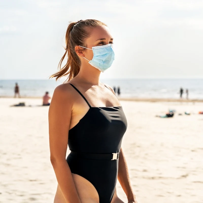 Woman Wearing A Facemask On The Beach