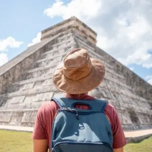 Young Man Exploring Ancient Archaeological Mayan City In Mexico