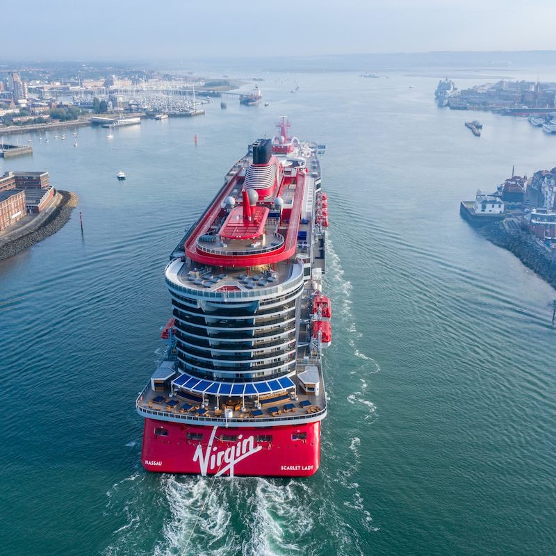 a Virgin Voyages cruise ship sails through the water