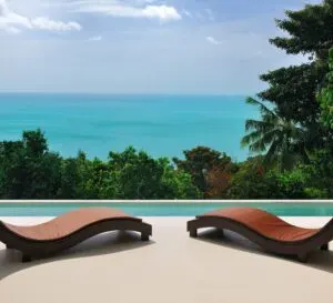 Brown chaise lounges at private pool villa