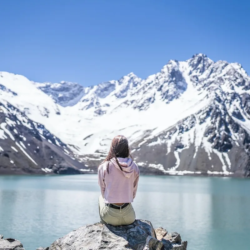 Woman looks at the landscape in the Andes Mountains near Santigao De Chile, Chile, Latin America