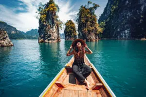 Happy Young Female Traveler Enjoying A Long Tail Boatride In Thailand