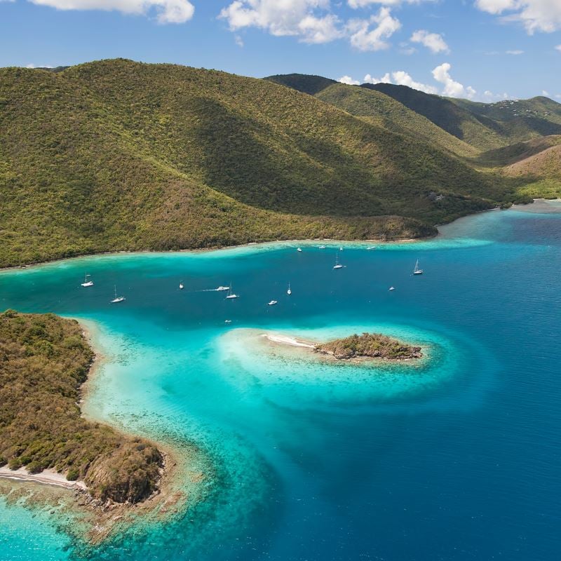 turquoise waters and sailboats in the distance in the Virgin Islands