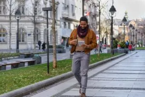 Young Male Tourist With Tablet In Hands Smiling While Walking The Streets Of Belgrade, Serbia