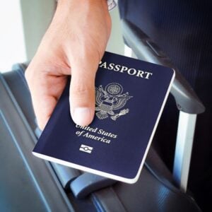 Male Traveler Holding A US Passport Ahead Of International Travel