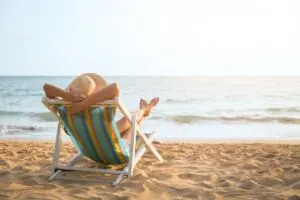 Woman Relaxing At The Beach On A Beach Lounge, Beach Vacation Concept
