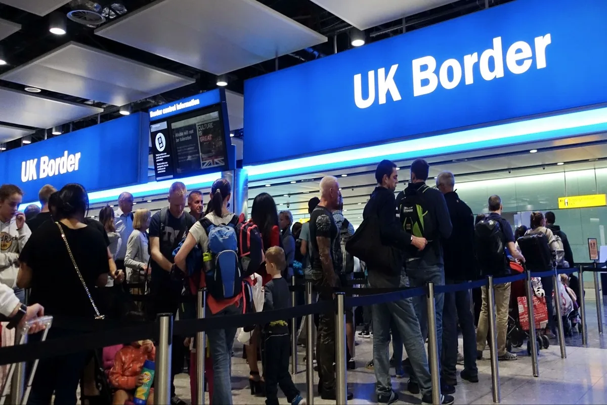 Passengers Waiting In Line Before Crossing The UK Border, United Kingdom
