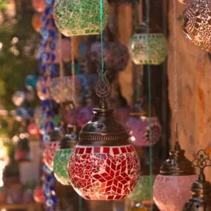 Turkish decorative lamps for sale at street market. Turkish mosaic lanterns hanging on the wall. Traditional souvenirs in old city of Antalya.