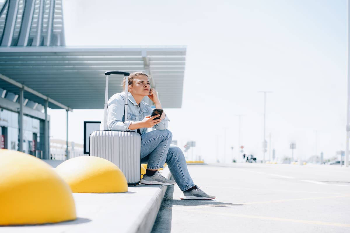 Young Man Looking Sad Or Disappointed At A Dropoff Pickup Point In An International Airport - Travel Off Path