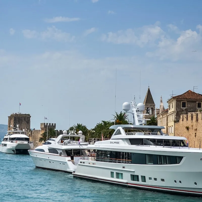 Yachts and tourist ships stationed at the marina of Trogir in Croatia