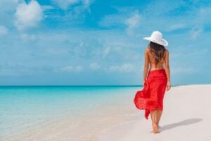 Young Female Tourist Enjoying Her Time At The Beach In The Cayman Islands, Caribbean Sea