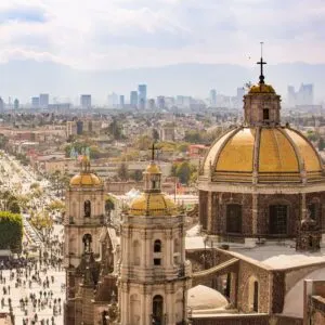 Mexico City Basilica with travelers walking in the backround on the streets