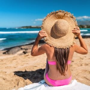 Beach,Girl,In,Pink,Bikini,Wearing,Floppy,Hat,Sun,Tanning