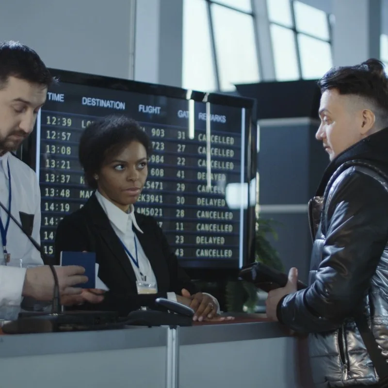 Young Male Traveler Having His Passport Checked At An International Airport, Air Travel