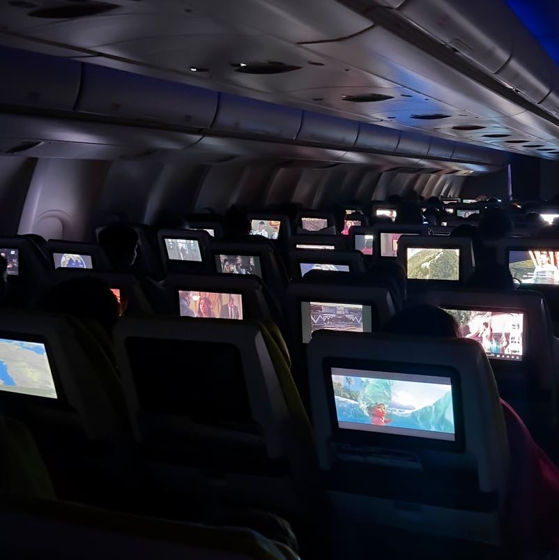 Interior of a plane at night with cabin lights off