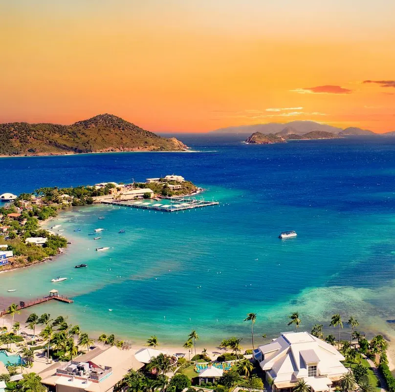 a fire orange sky at sunset contrasts beautifully with the deep blue and turquoise waters of St. Thomas USVI