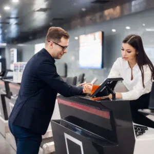 A man in a suit shows his REAL ID at airport check in