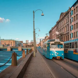 Blue Trams Moving Through The Canal Streets Of Gothenburg, Sweden