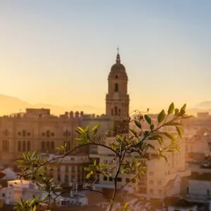 Sunset from the walls of the Alcazaba of the city of Malaga and in the background the Cathedral of the Incarnation of Malaga, Andalusia. Spain. Medieval fortress in arabic style
