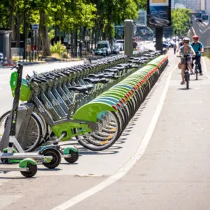 a row of bright green bikes line a bike path in Paris