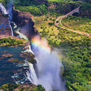 Rainbow over Victoria Falls in Zimbabwe, sunny day in Africa