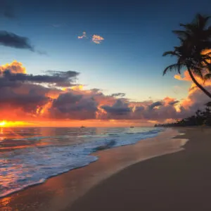 a bright orange sun can be seen between the clouds and the sea from a beach in the Bahamas