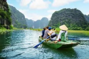 Tourists On A Boat In A Picturesque River In Vietnam, Southeast Asia
