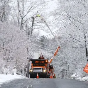 Truck repairing power lines after a winter snow storm