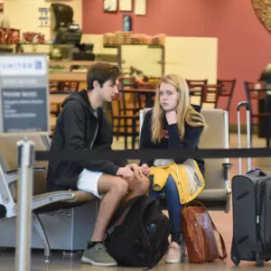 teenagers fight boredom as they await their flight at RDU International airport.