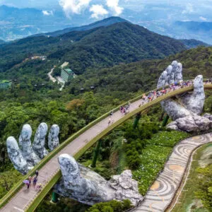 Aerial View Of Da Nang, A Pedestrian Bridge Supported By Giant Hands In The Middle Of A Tropical Jungle In Vietnam, Southeast Asia