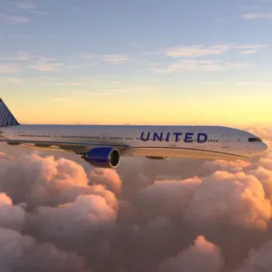 Boeing 777 United Airlines flying over amazing sunset
