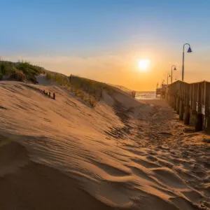Dunes and the Sandbridge Fishing Pier in Sandbridge Virginia, Virginia Beach during a sunrise. Pastel colors and a dreamy look