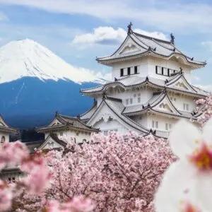 Top Layers Of Himeji Castle Seen Amid A Sea Of Cherry Blossoms With Mount Fuji In The Background, Japan