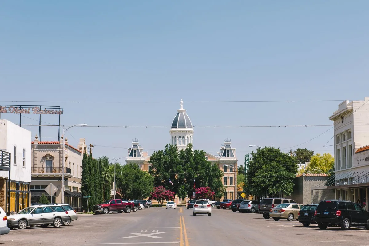 Marfa Texas town street with car driving down the road