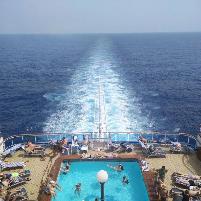 travelers enjoying pool at cruise deck