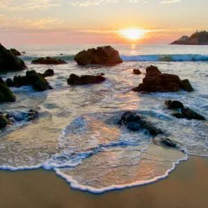 rock in water at Playa Zicatela, Oaxaca mexico