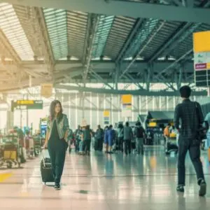 Travelers Transiting An International Airport At An Unspecified Location