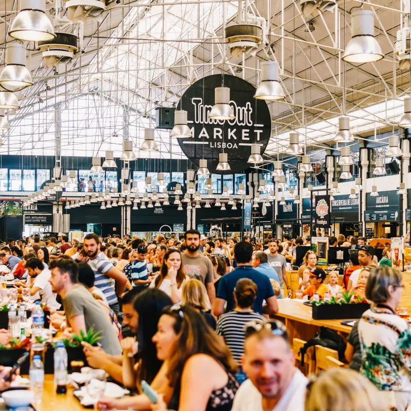 A food hall with lots of people eating. A food hall with lots of people eating.