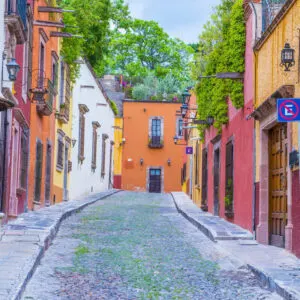 A Charming Street Lined With Colorful Buildings In San Miguel de Allende, State Of Guanajuato, Mexico