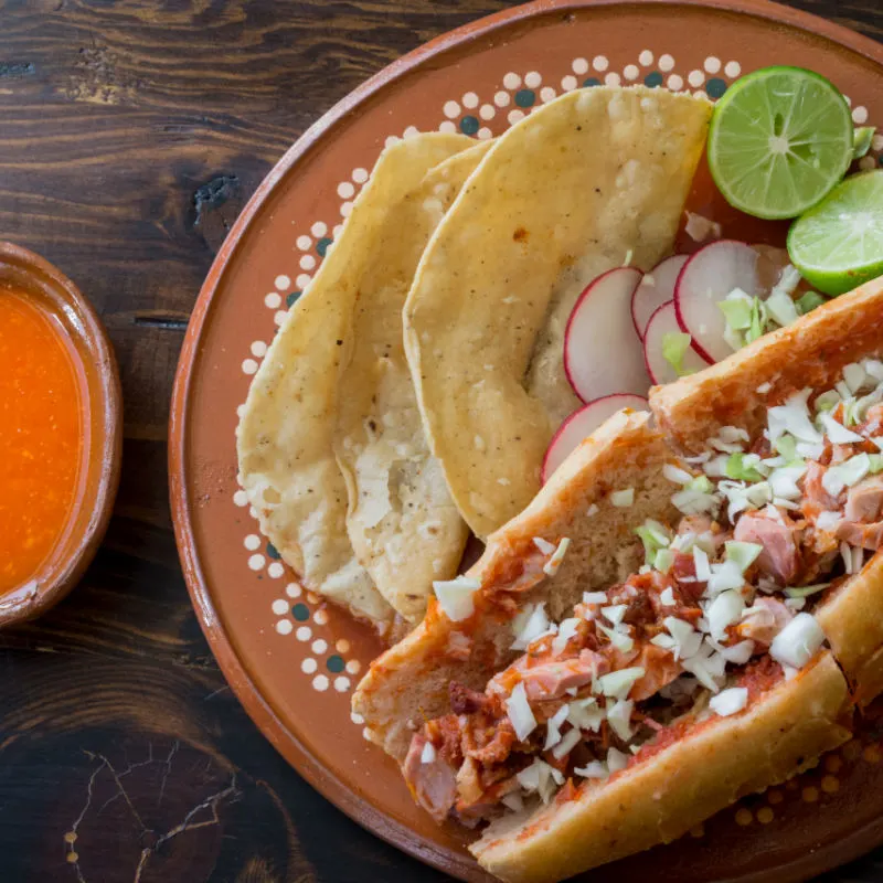 A plate with a torta ahogada or drowned sandwhich, a specialty cuisine of Guadalajara, Mexico