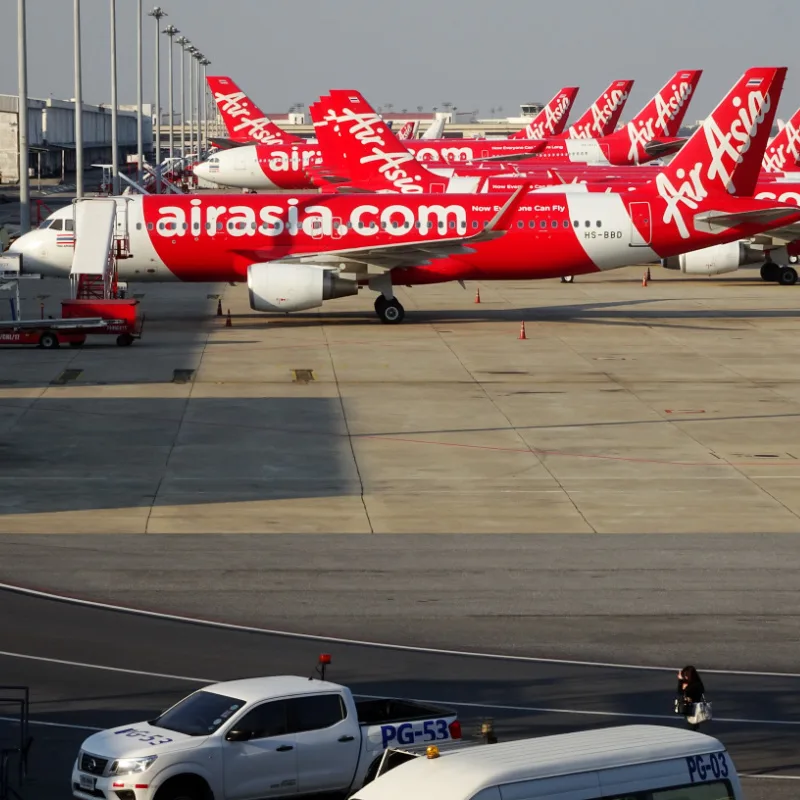 Red and white plans on a tar mac waiting to take off