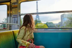Woman on a train watching the Eiffel Tower
